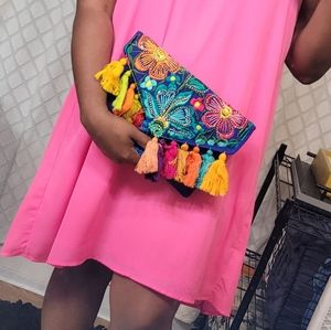 Hot pink dress with colorful accentsa around the front of the arm holes